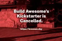 A red-tinted photograph of a graffiti-covered urban street corner, featuring a fallen bicycle leaning against a building. Bold white text overlaid on the image reads: 'Build Awesome's Kickstarter is Cancelled.' with the URL 'https://brennan.day' below.