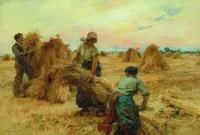 Oil painting of three farm workers binding wheat sheaves into stooks at sunset. A man on the left lifts a bundle of wheat onto a stack, a woman in a white blouse and bonnet carries an armful of cut wheat toward the stack, and a second woman crouches in the foreground gathering stalks. Rows of wheat stooks dot the golden stubble field under a pastel sky with a low orange sun on the horizon. Signed 'L. Lhermitte' in the lower left.