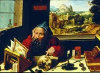 Northern Renaissance oil painting of an elderly bearded scholar in a red robe and blue cap, seated at a cluttered desk, resting his head on one hand while pointing at a human skull with the other. The desk holds an open illuminated manuscript, a book labeled 'Biblia Greca,' a Hebrew scroll, an hourglass, a candle, spectacles, and a penknife. A red plaque above reads 'COGITA MORI' (contemplate death). Through an open window behind him, a landscape unfolds with a hilltop castle, a village, and small figures on a road.
